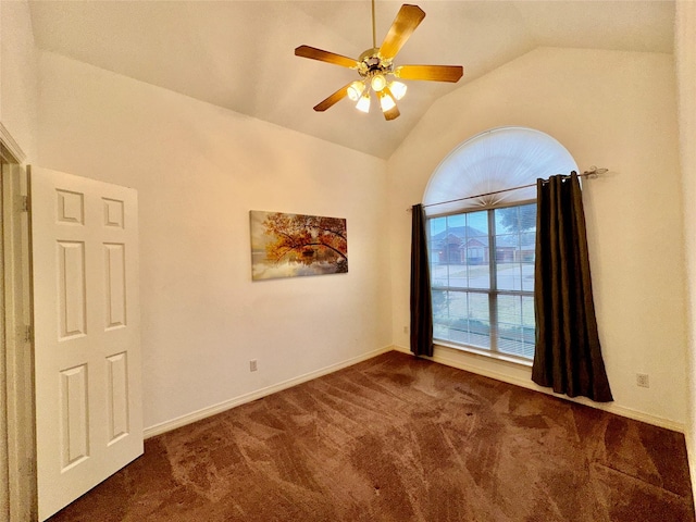 carpeted spare room with ceiling fan and vaulted ceiling