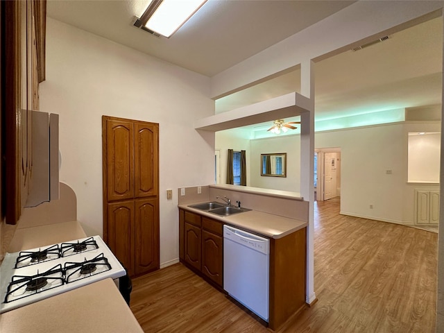 kitchen with light wood-type flooring, dishwasher, sink, and gas range