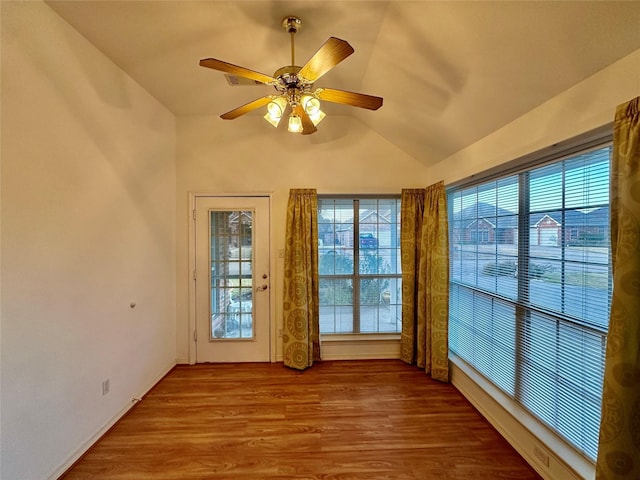 unfurnished sunroom featuring vaulted ceiling and ceiling fan