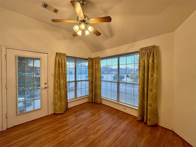 spare room with ceiling fan, hardwood / wood-style flooring, and vaulted ceiling