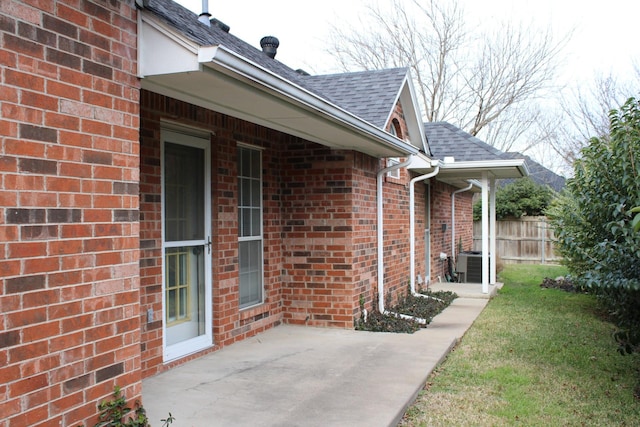 exterior space featuring a patio, a lawn, and central air condition unit