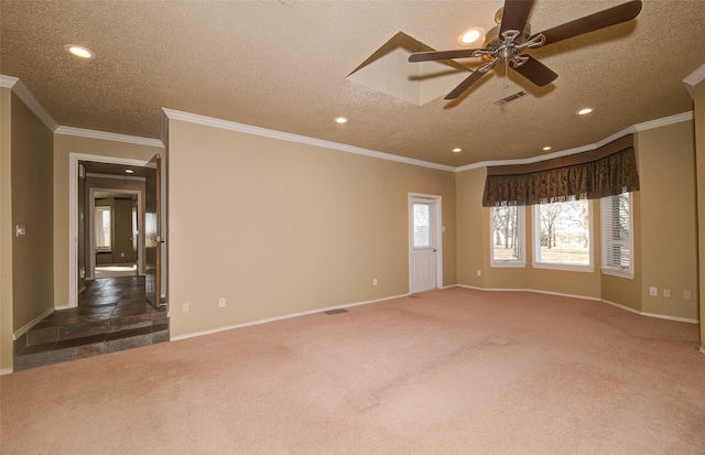 carpeted spare room with crown molding, ceiling fan, and a textured ceiling