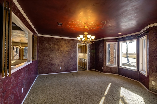 carpeted empty room with ornamental molding and a chandelier