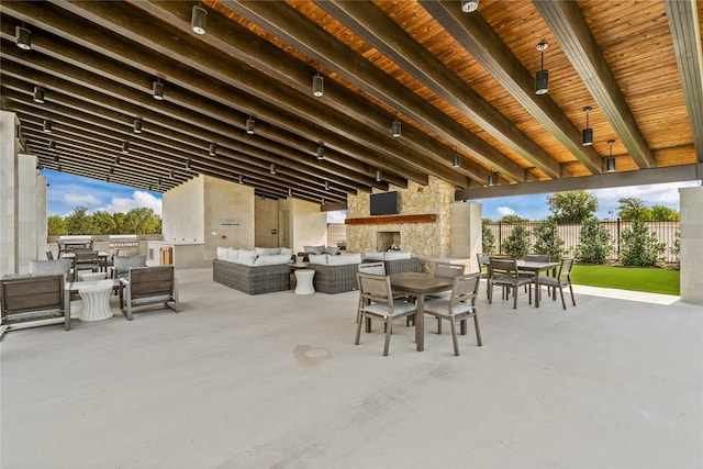 view of patio with an outdoor living space with a fireplace