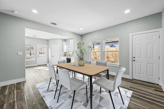 dining space with sink and dark hardwood / wood-style floors