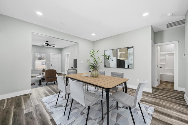 dining area with ceiling fan and hardwood / wood-style floors