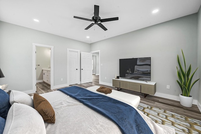 bedroom featuring ceiling fan, ensuite bathroom, and hardwood / wood-style flooring