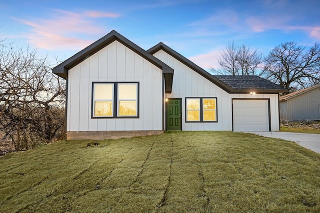 modern farmhouse style home featuring a garage and a lawn