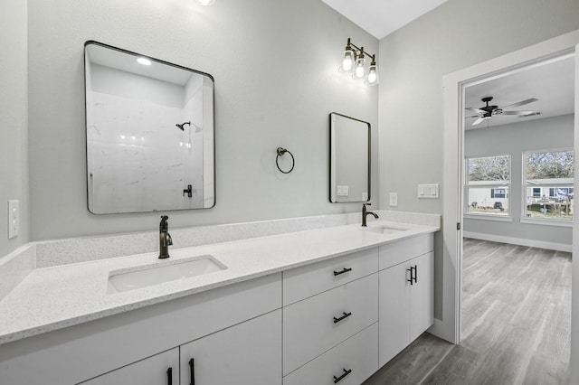 bathroom featuring ceiling fan, a shower, hardwood / wood-style floors, and vanity