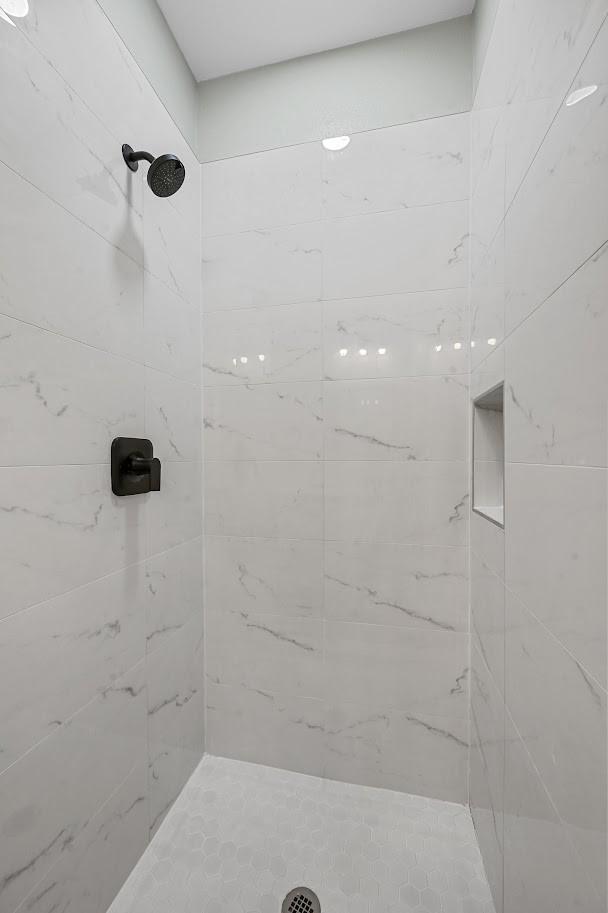 bathroom with tiled shower