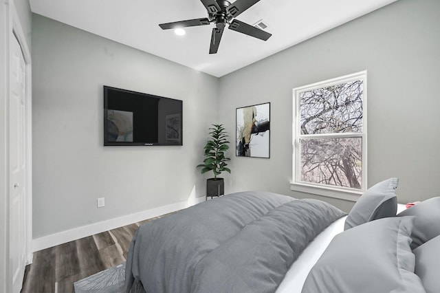 bedroom with ceiling fan and dark wood-type flooring