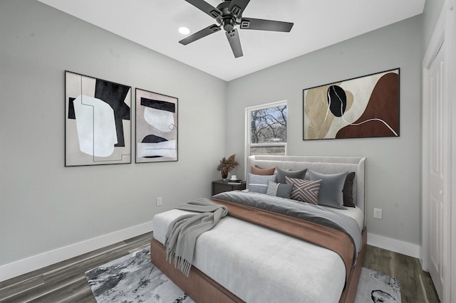 bedroom with ceiling fan and dark hardwood / wood-style floors