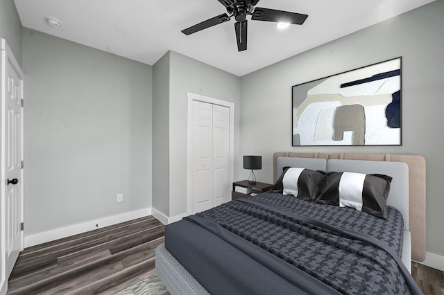 bedroom featuring ceiling fan, dark hardwood / wood-style floors, and a closet