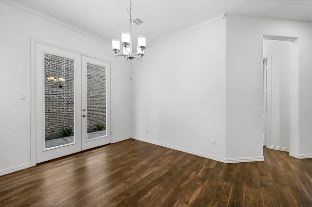 unfurnished dining area featuring dark wood-type flooring, ornamental molding, french doors, and a notable chandelier