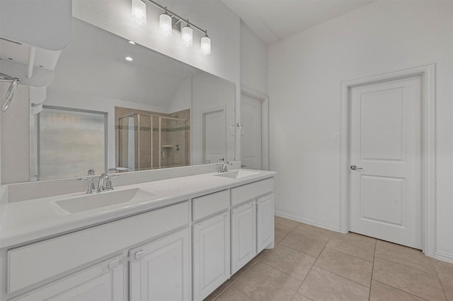 bathroom with walk in shower, vanity, and tile patterned flooring