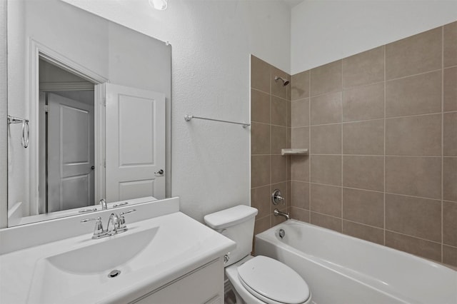 full bathroom with toilet, tiled shower / bath combo, and vanity