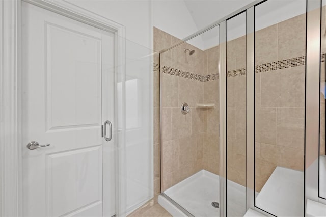 bathroom with a shower with door