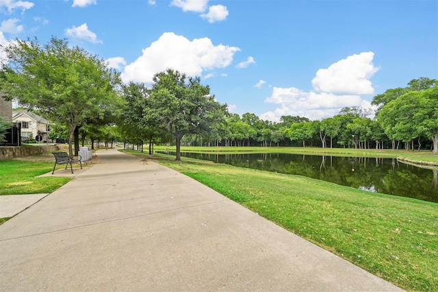 view of home's community featuring a yard and a water view