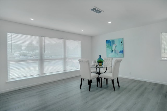 dining space with light hardwood / wood-style floors