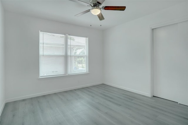 spare room with ceiling fan and light hardwood / wood-style flooring