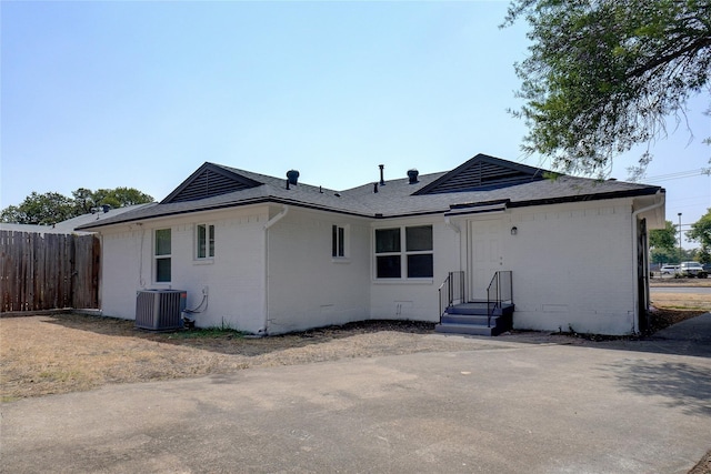 rear view of house featuring central air condition unit