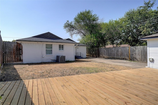 wooden deck featuring central air condition unit