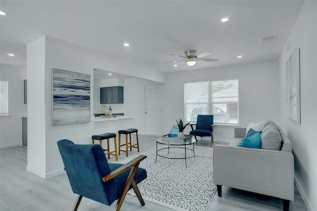 living room featuring ceiling fan and light wood-type flooring