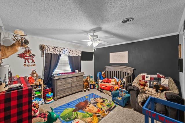 carpeted bedroom featuring ceiling fan, a textured ceiling, crown molding, and a crib