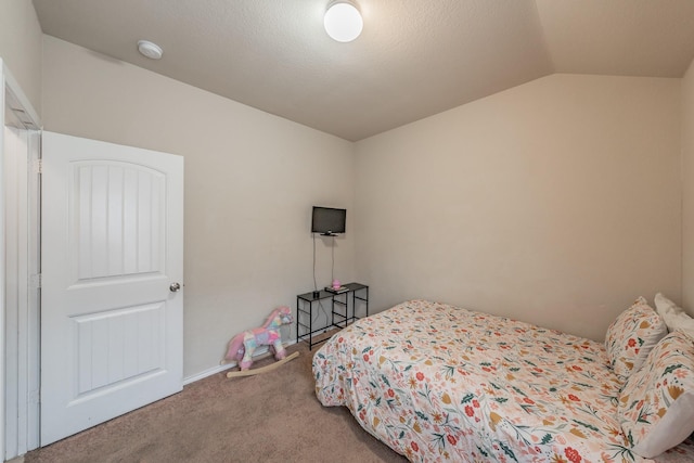 carpeted bedroom featuring vaulted ceiling