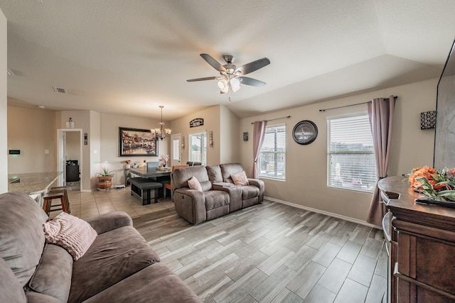 living room with ceiling fan with notable chandelier