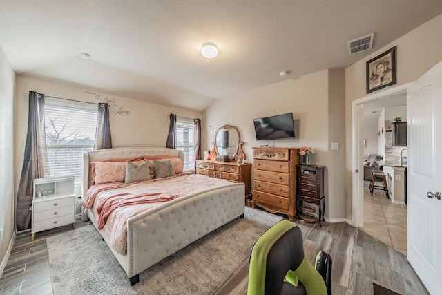 bedroom featuring lofted ceiling