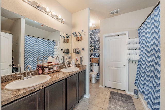 bathroom featuring toilet, vanity, walk in shower, and tile patterned flooring