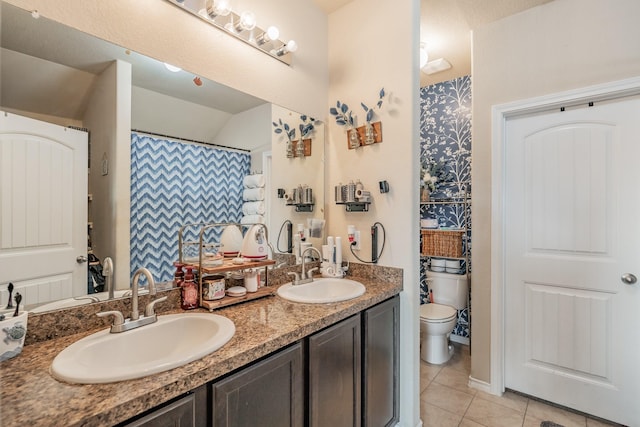 bathroom featuring toilet, tile patterned floors, and vanity