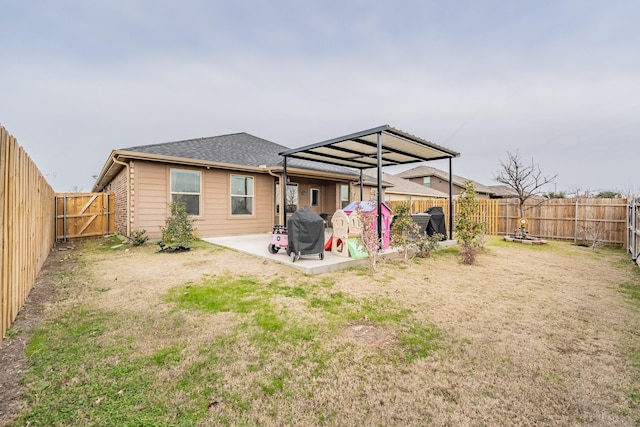 back of house featuring a patio area and a yard