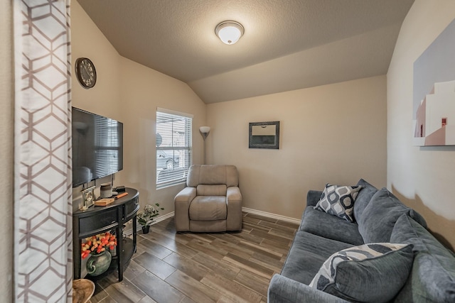 living room with a textured ceiling and vaulted ceiling