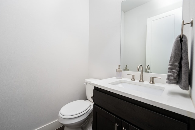 bathroom with toilet and vanity