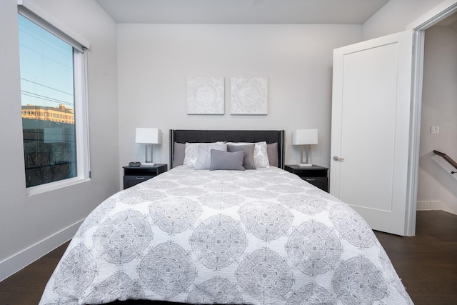 bedroom with dark hardwood / wood-style flooring