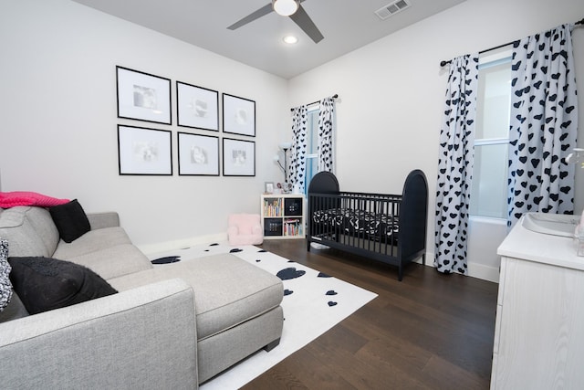 living room with ceiling fan and dark hardwood / wood-style flooring