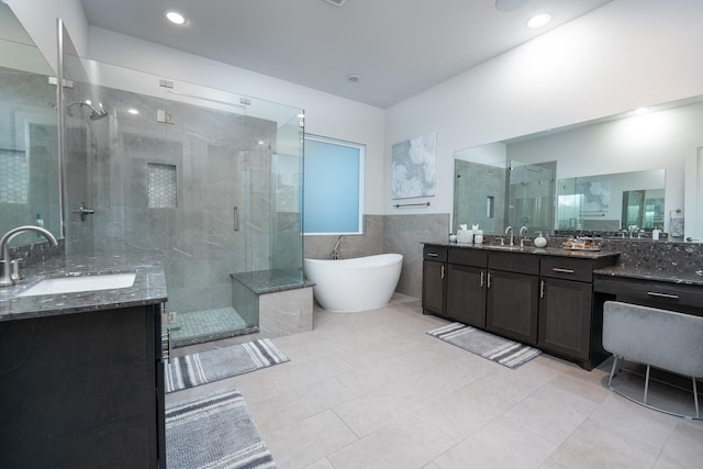 bathroom featuring tile walls, tile patterned floors, vanity, and shower with separate bathtub