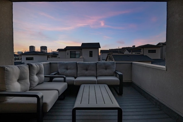 deck at dusk with outdoor lounge area