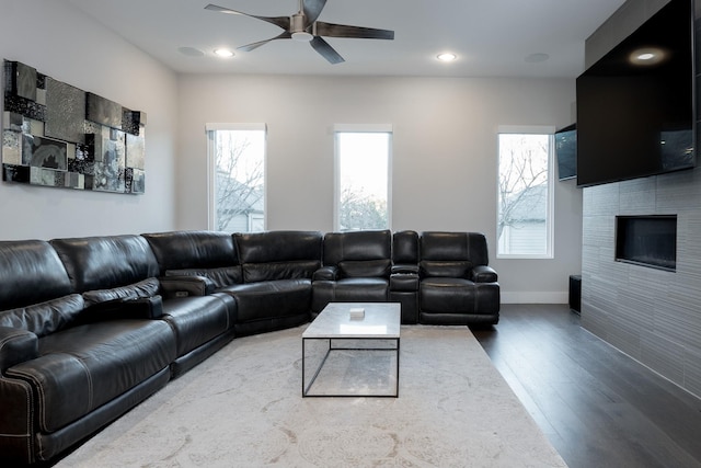 living room with hardwood / wood-style flooring, ceiling fan, and plenty of natural light