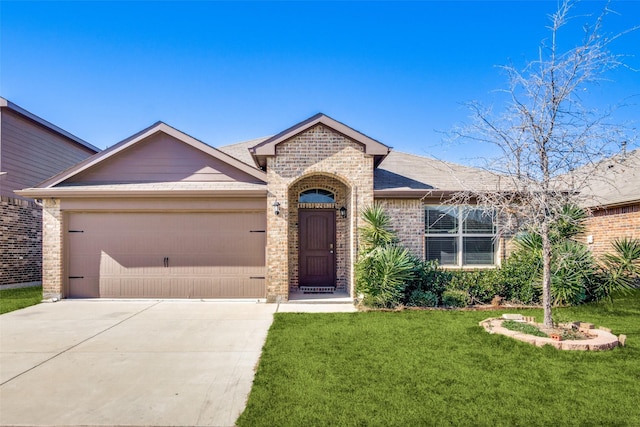 view of front of property with a garage and a front lawn