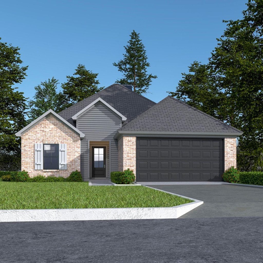 view of front of house featuring a front lawn and a garage