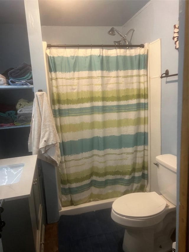 bathroom featuring toilet, vanity, and a shower with shower curtain