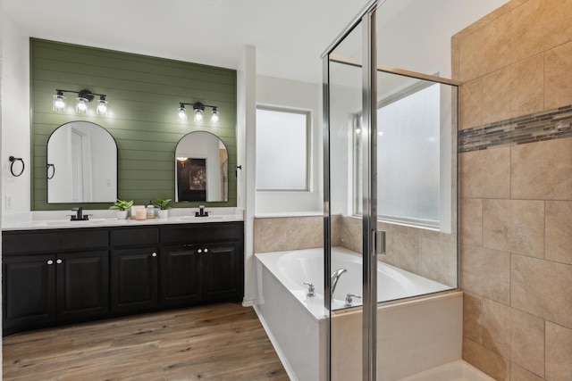 bathroom featuring vanity, separate shower and tub, and hardwood / wood-style floors