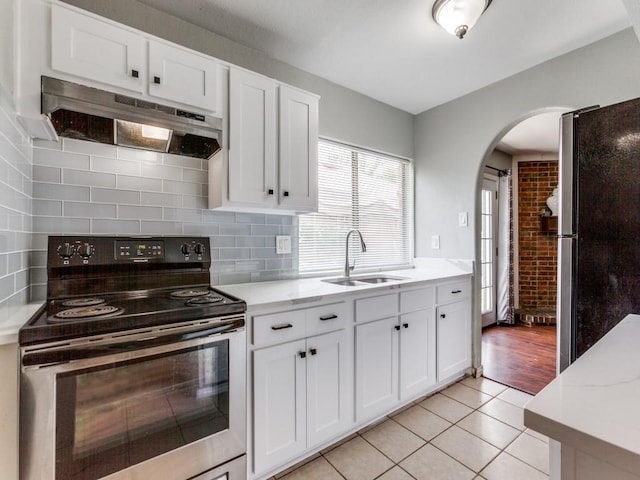 kitchen featuring sink, white cabinets, appliances with stainless steel finishes, and light tile patterned flooring