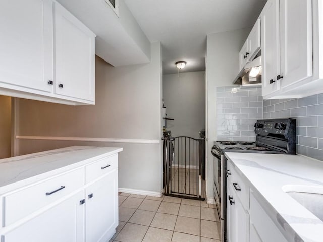 kitchen featuring white cabinetry, decorative backsplash, light tile patterned flooring, black range with electric cooktop, and light stone counters