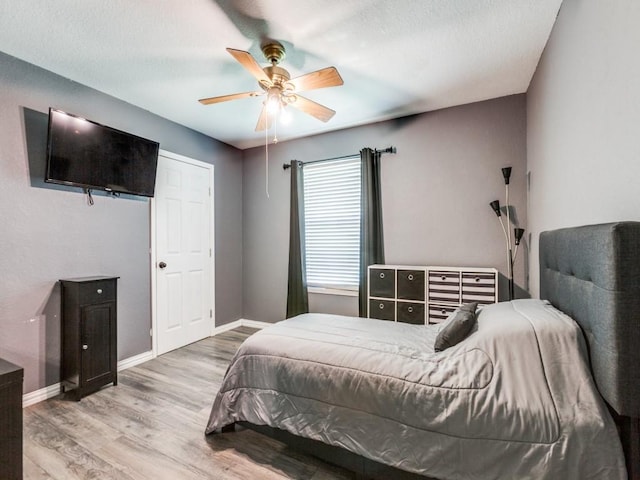 bedroom featuring ceiling fan and light hardwood / wood-style floors