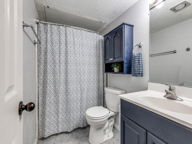 bathroom featuring a textured ceiling, toilet, tile patterned floors, and vanity