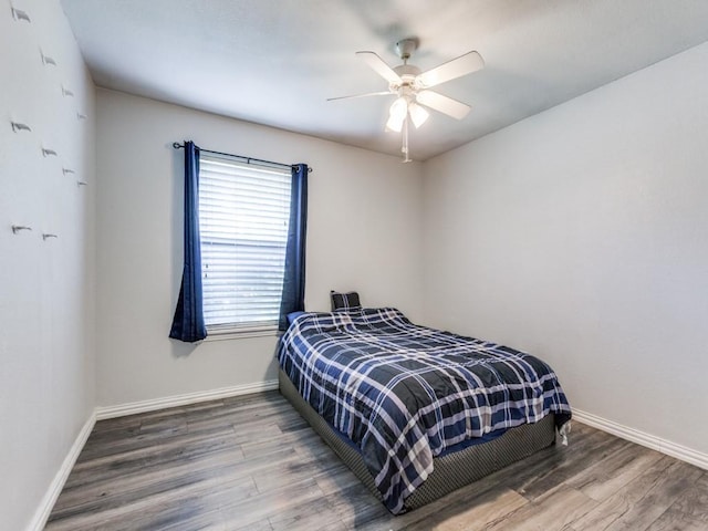 bedroom featuring ceiling fan and hardwood / wood-style floors